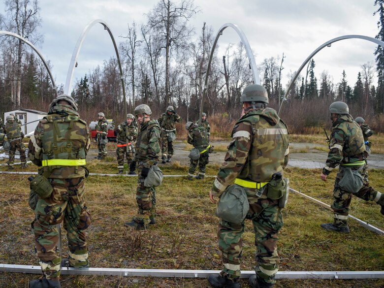 U.S. Airmen with the 773d Civil Engineer Squadron construct a tent during exercise Polar Force 19-1 at Joint Base Elmendorf-Richardson, Alaska, Oct. 24, 2018. Exercise Polar Force showcases unit combat readiness while fighting in chemical, biological, radiological and nuclear defense protective gear.