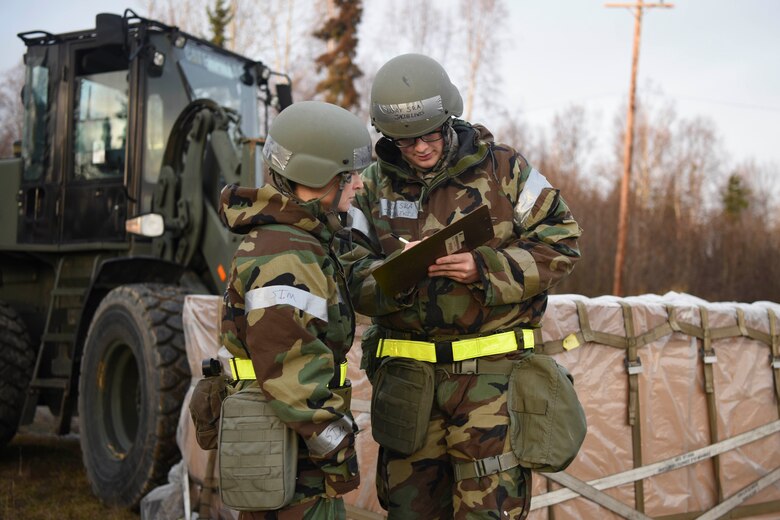 U.S. Air Force Senior Airman Jacob Lewis and Airman 1st Class Yuliya Brazina, both 773d Logistics Readiness Squadron inspects paperwork for a cargo plan during exercise Polar Force 19-1 at Joint Base Elmendorf-Richardson, Alaska, Oct. 24, 2018. For this iteration of PF 19-1, more than 300 Airmen from 10 different units participated, each with support functions enabling each other to get the mission accomplished.