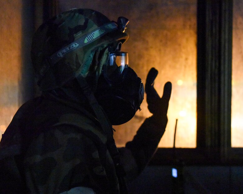 U.S. Air Force Senior Airman Mark Mugo, 773d Civil Engineer Squadron, puts on protective gear during exercise Polar Force 19-1 at Joint Base Elmendorf-Richardson, Alaska, Oct. 25, 2018. Exercise Polar Force showcases unit combat readiness while fighting in chemical, biological, radiological and nuclear defense protective gear.