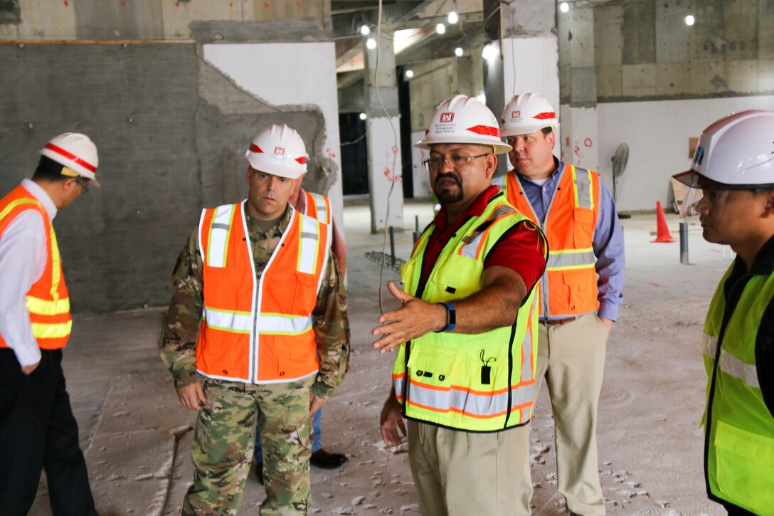 Misawa Resident Office Resident Engineer Guillermo Provencio shows the ongoing school renovation to Japan District Commander Col. Thomas J. Verell Jr. and District Deputy Engineer for Programs and Project Management Division John N. Peukert during their visit to the Misawa Resident Office.