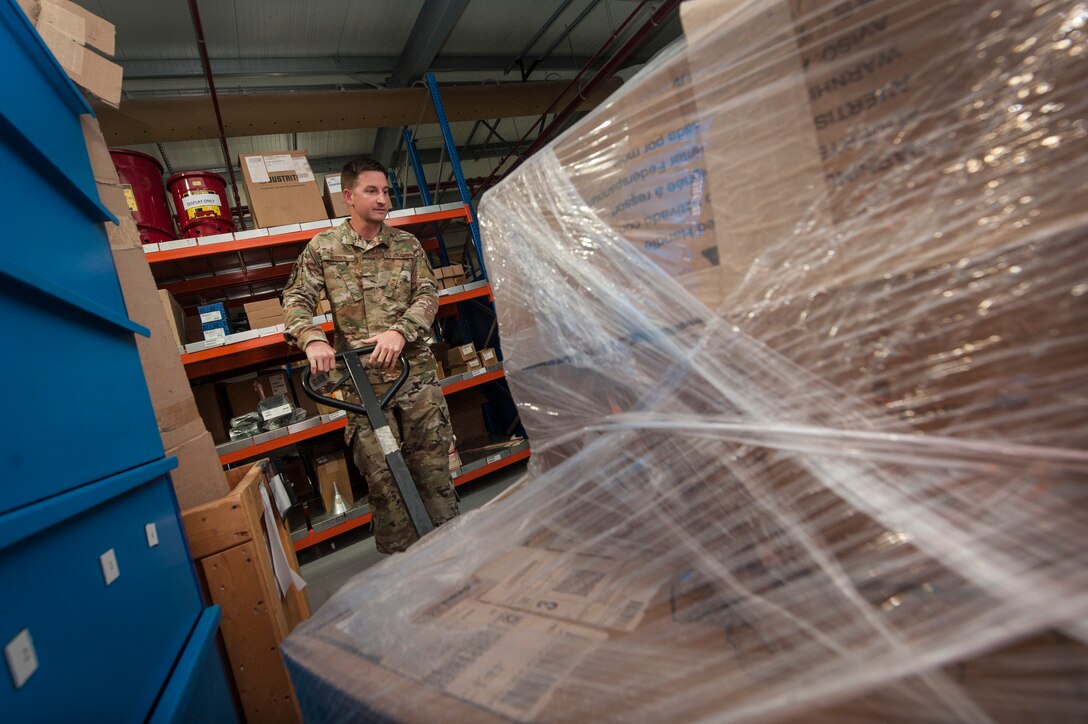 Airman 1st Class Dustin Marin, 379th Expeditionary Logistics Readiness Squadron materiel management technician, moves a pallet of assets at the newly relocated Desert Depot Oct. 30, 2018, at Al Udeid Air Base, Qatar. The 379th ELRS recently relocated the Desert Depot, celebrating the moves completion during a ribbon cutting ceremony. The ceremony culminates a two year effort to relocate to a $1.1 million facility. Airmen of the 379th ELRS pulled together to move 42,000 assets to the new location during a four-day period. (U.S. Air Force photo by Tech. Sgt. Christopher Hubenthal)