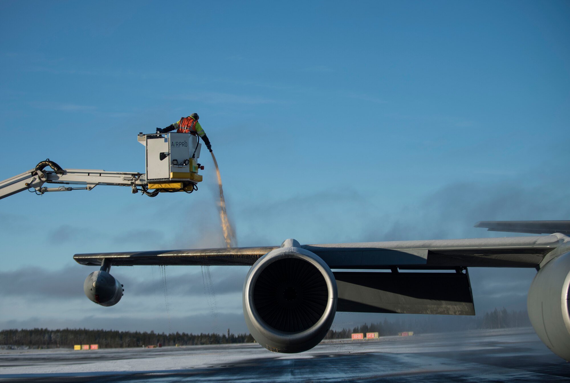 Airport personnel de-ice a U.S. Air Force KC-135 Stratotanker prior to takeoff during Exercise Trident Juncture 18, at Rovaniemi, Finland, Oct. 30, 2018. The exercise is the largest NATO exercise since 2015, and includes more than 50,000 military members from 31 countries. (U.S. Air Force photo by Senior Airman Luke Milano)