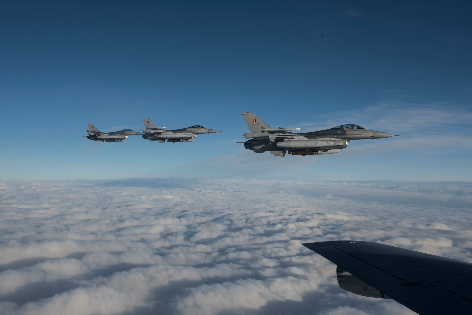 Three Belgian F-16 Fighting Falcons fly alongside a U.S. Air Force KC-135 Stratotanker during Exercise Trident Juncture 18, in Swedish airspace, Oct. 30, 2018. The NATO-led exercise includes 31 countries and provides unique opportunities to train with NATO allies and partners. (U.S. Air Force photo by Senior Airman Luke Milano)