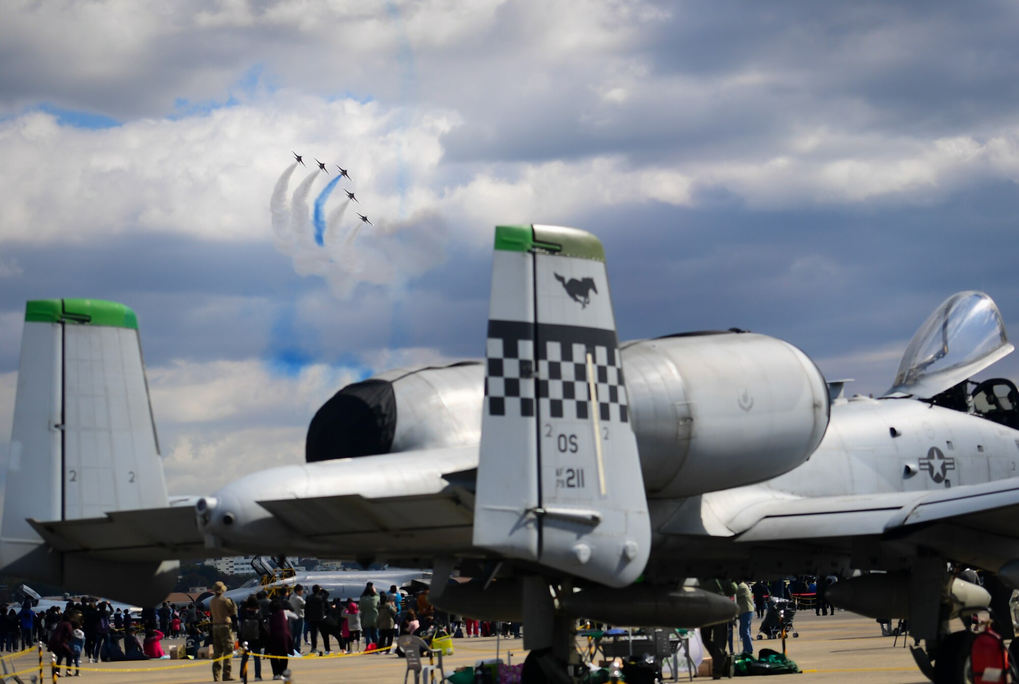 The Republic of Korea’s 53rd Demonstration Group, also known as the Black Eagles, fly above an A-10 Thunderbolt II as they perform at the Gyeongnam Sacheon Aerospace Expo at Sacheon Air Base, South Korea, Oct. 25, 2018.