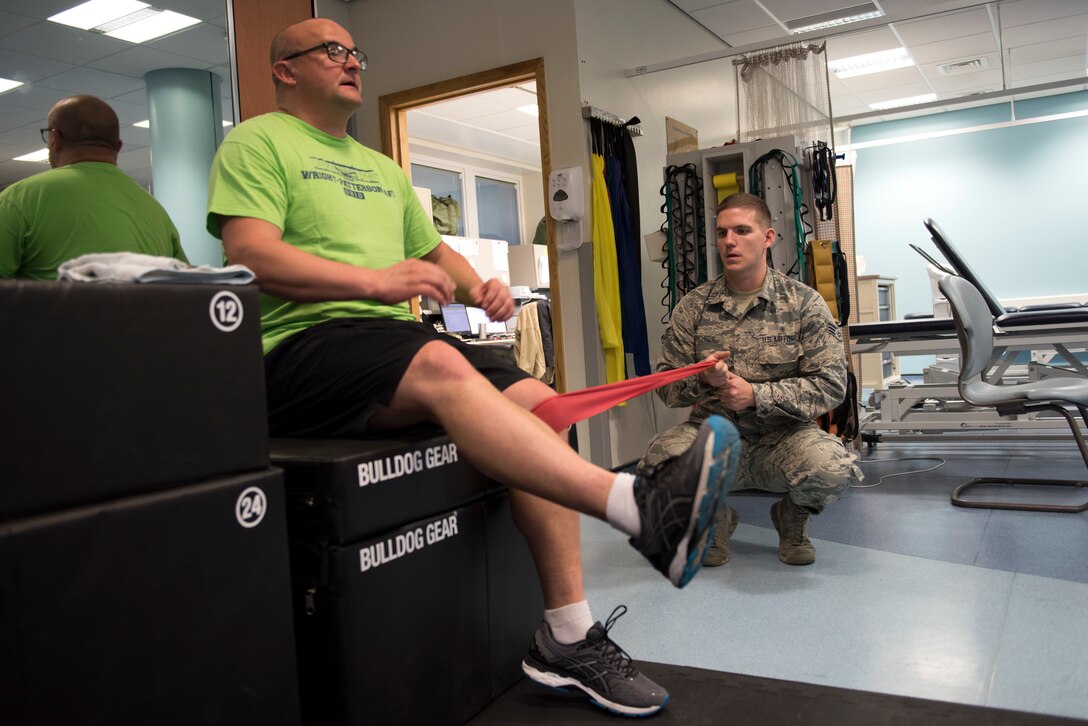 Senior Airman Joshua Dorcheus, 48th Medical Operations Squadron physical medicine technician, shows 1st Lt. Ladislav Kucera, 48th Medical Support Staff lab operations chief, targeted muscle strengthening techniques in the Physical Therapy Clinic at Royal Air Force Lakenheath, England, Oct. 30. Technicians provide care specifically designed for each patient to efficiently recover. (U.S. Air Force photo/ Senior Airman Malcolm Mayfield)