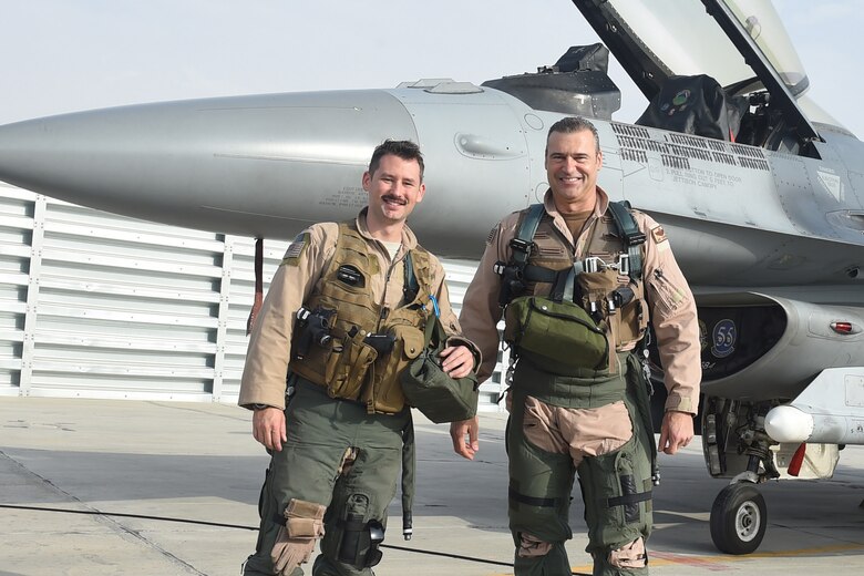 A pilot and crew chief prepare an F-16 Fighting Falcon for take off.