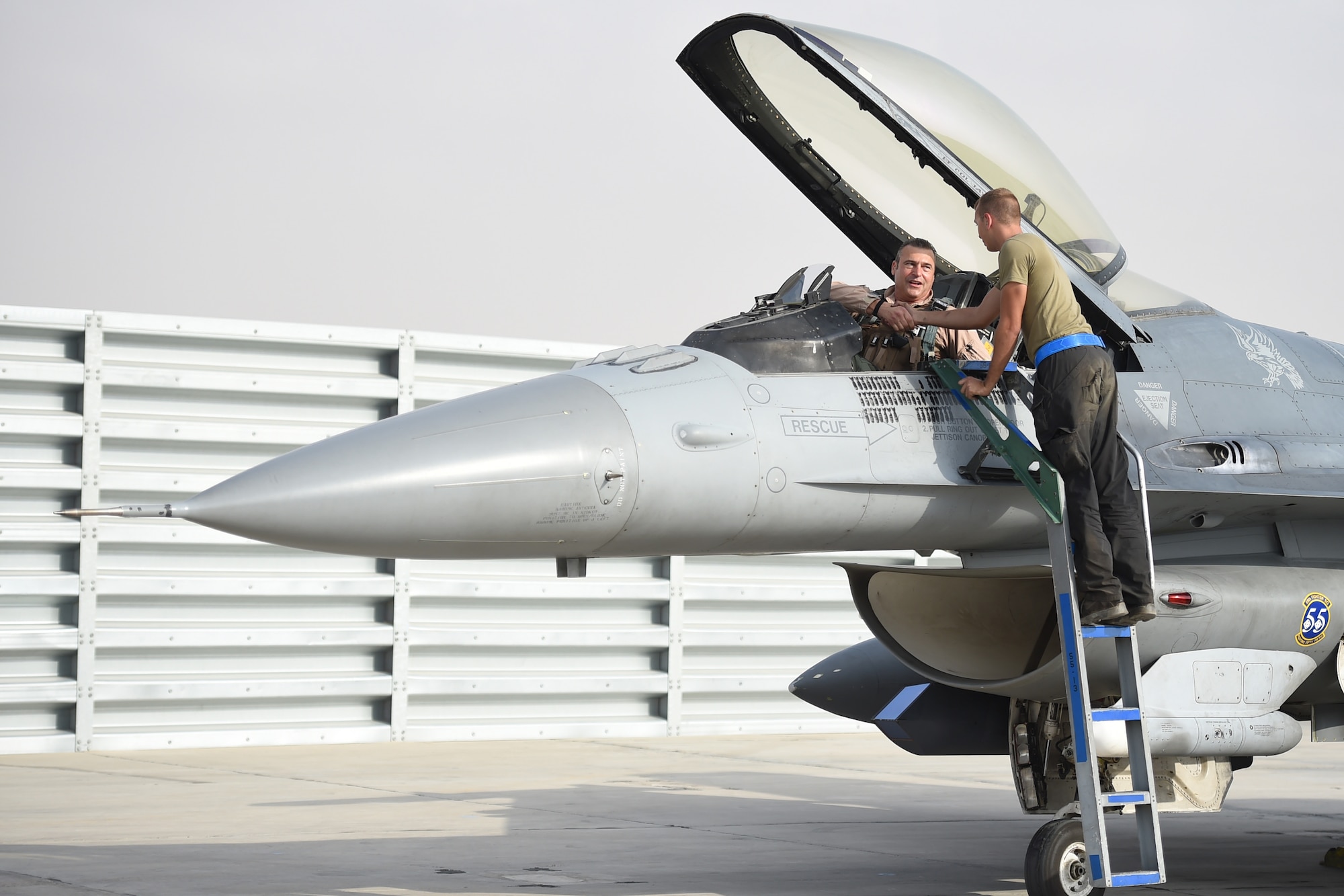 A pilot and crew chief prepare an F-16 Fighting Falcon for take off.