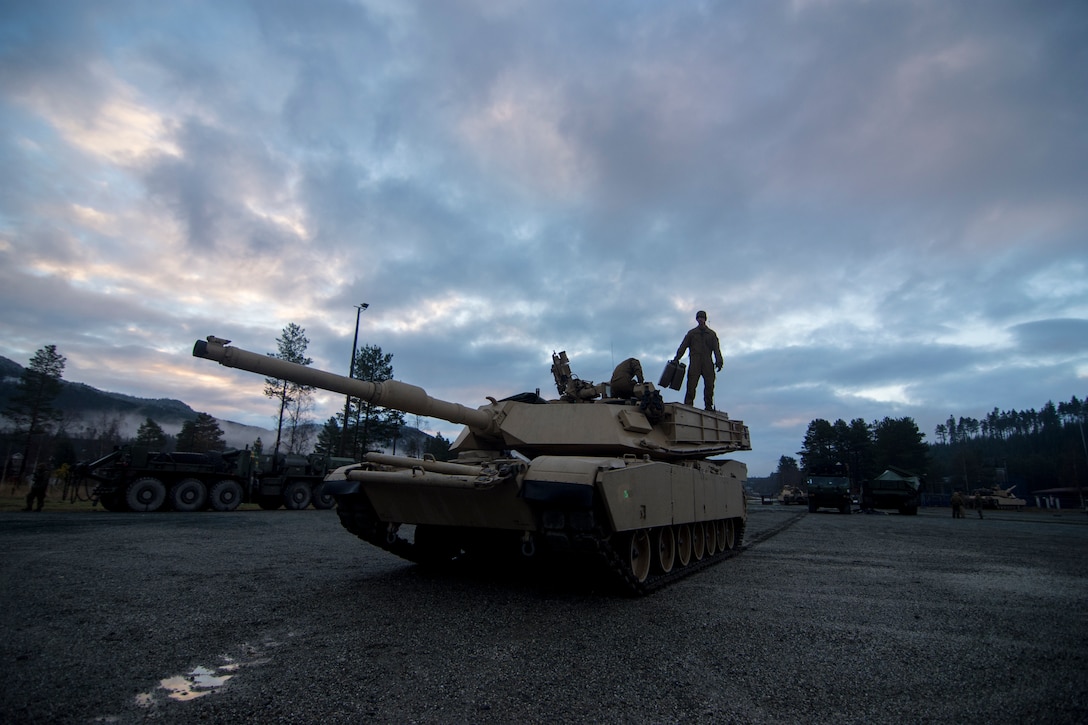 U.S. Marines from 2nd Tank Battalion, 2nd Marine Division, use the early morning daylight to prepare their M1A1 Abrams tank for the Combat Enhancement Training/Force Integration Training phase of Exercise Trident Juncture 18 near Storås, Norway, Oct. 26, 2018. Trident Juncture is a multinational NATO exercise that enhances professional relationships and improves overall coordination with Allied and partner nations.