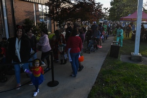 Community members wait for the Night at the Transportation Museum event at the U.S. Army Transportation Museum at Joint Base Langley-Eustis, Virginia, Oct. 29, 2018. Volunteers dressed in U.S. Army uniforms from different time periods and passed out candy in exhibits decorated for Halloween. (U.S. Air Force photo by Senior Airman Derek Seifert)