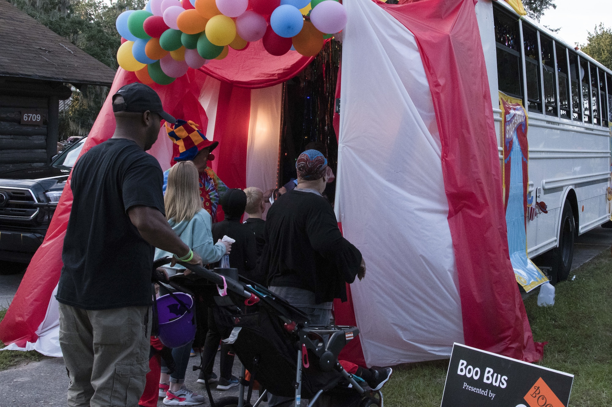 Keesler families enter the Boo Bus during Ghouls in the Park at Marina Park at Keesler Air Force Base, Mississippi, Oct. 26, 2018. The Halloween event also featured a haunted house and various games for children of all ages. (U.S. Air Force photo by Airman 1st Class Suzie Plotnikov)