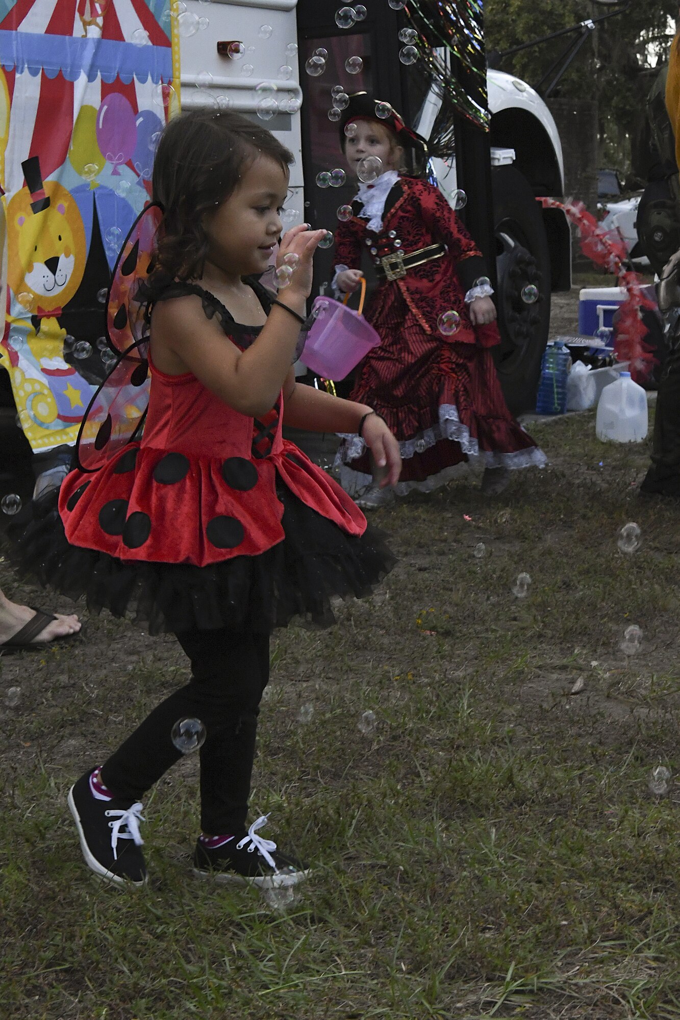 Lilyanne Fine, daughter of U.S. Air Force Senior Master Sgt. (Ret.) Barrett Fine, pops bubbles during Ghouls in the Park at Marina Park at Keesler Air Force Base, Mississippi, Oct. 26, 2018. Ghouls in the Park also featured the Boo Bus, a haunted house and various games for children of all ages. (U.S. Air Force photo by Airman 1st Class Suzie Plotnikov)
