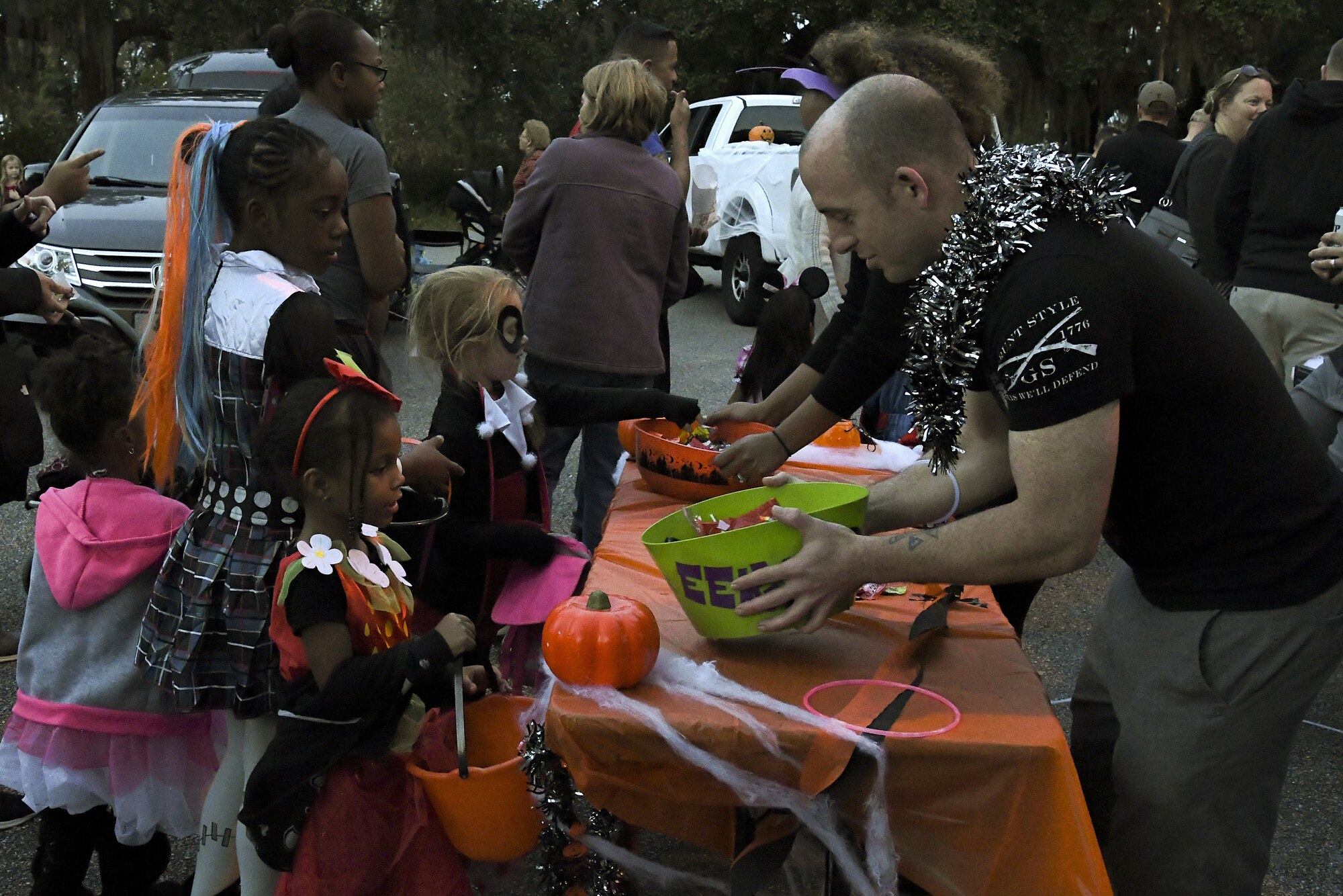 Keesler families collect candy during Ghouls in the Park at Marina Park at Keesler Air Force Base, Mississippi, Oct. 26, 2018. The Halloween event also featured the Boo Bus, a haunted house and various games for children of all ages. (U.S. Air Force photo by Airman 1st Class Suzie Plotnikov)