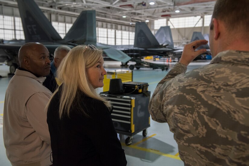 Academy of Hampton teachers listen to U.S. Air Force Capt. Greg Hoyt, 1st Maintenance Group fabrication flight commander, during a tour to learn about real-world logistical applications at Joint Base Langley-Eustis, Virginia, Oct. 26, 2018.