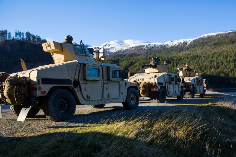 HMMWV’s prepare for a convoy at Alvund Beach during Trident Juncture 18, Oct. 29, 2018 after being delivered ashore from USS Iwo Jima (LHD-7). The Marines and vehicles were transported via the U.S. Navy’s landing craft air cushion which rapidly brought Marine Corps combat power from the ship to the shore. Trident Juncture exercises tactics and procedures in different environments which enables forces to remain ready and improve interoperability. The amphibious landing prepares the 24th Marine Expeditionary Unit to work effectively, swiftly and collectively to respond to threats in any location. (U.S. Marine Corps photo by Lance Cpl. Margaret Gale)