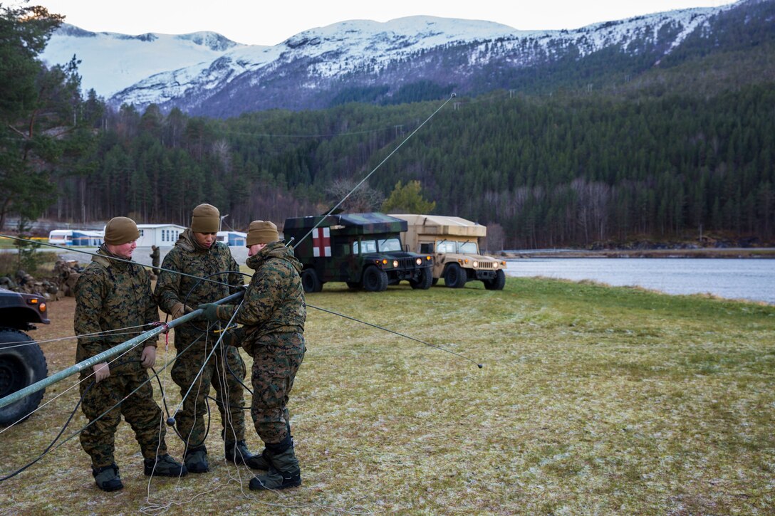 Marines establish communications during Trident Juncture 18 on Alvund Beach, Oct. 29, 2018 after being delivered ashore from USS Iwo Jima (LHD-7). The Marines and vehicles were transported via the U.S. Navy’s landing craft air cushion which rapidly brought Marine Corps combat power from the ship to the shore. Trident Juncture exercises tactics and procedures in different environments which enables forces to remain ready and improve interoperability. The amphibious landing prepares the 24th Marine Expeditionary Unit to work effectively, swiftly and collectively to respond to threats in any location. (U.S. Marine Corps photo by Lance Cpl. Margaret Gale)