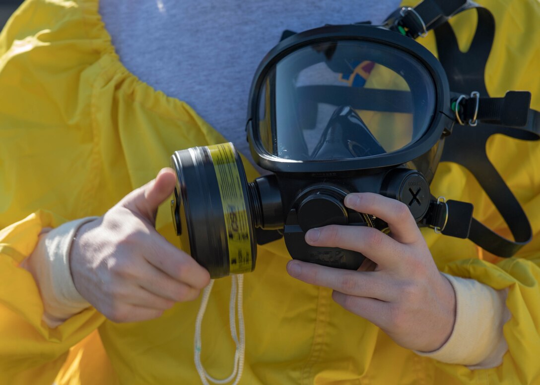 A U.S. Air Force Airman assigned to the 633rd Civil Engineer Squadron attaches a filter to his mask during a joint radiological response training at Joint Base Langley-Eustis, Virginia, Oct. 3, 2018.