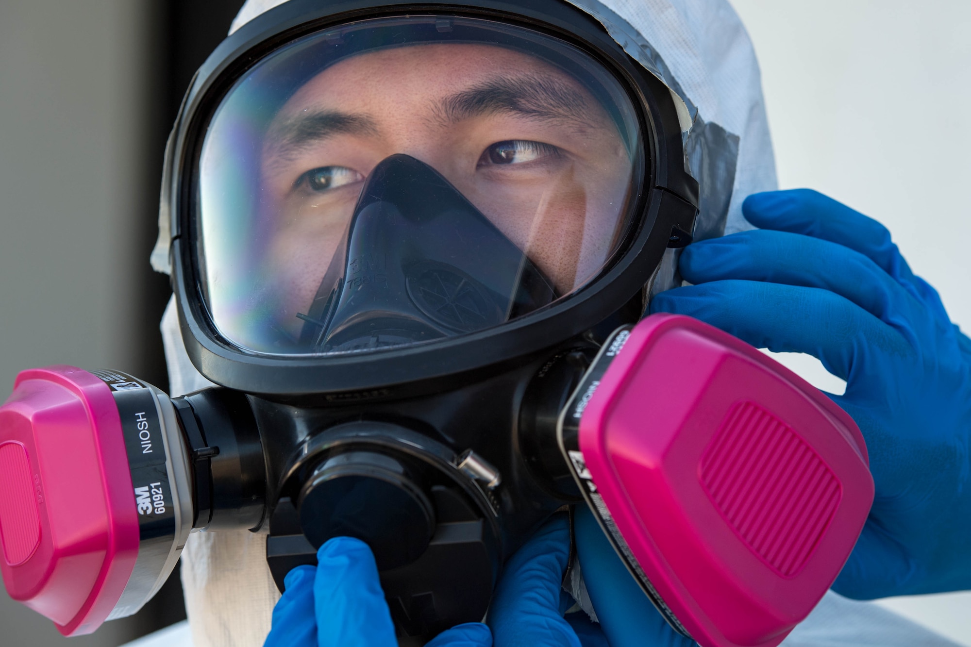 U.S. Air Force Senior Airman Yoonhong Min, 633rd Aerospace Medicine Squadron bioenvironmental technician dons his gas mask during a joint radiological response training at Joint Base Langley-Eustis, Virginia, Oct. 3, 2018.