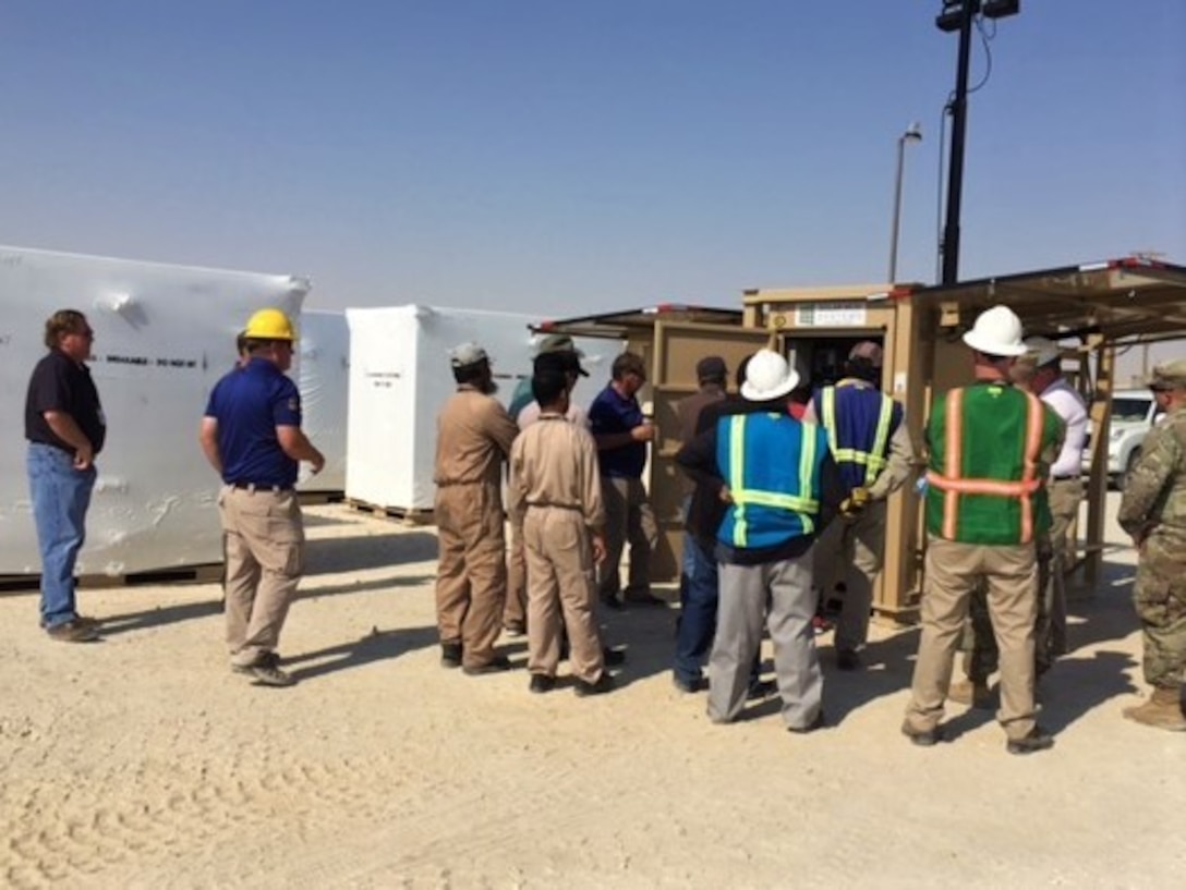 Representatives from the Camp Arifjan, Kuwait, Director of Public Works, Idaho National Labs and their expeditionary resource efficiency managers participate in a demonstration of the solar light cart with hydration unit option at Camp Arifjan, Kuwait, Oct. 3, 2018. The demonstration allowed for the DPW and their operations and maintenance personnel to be aware of how to properly set up the units and how to operate and maintain the units to ensure maximum efficiencies.