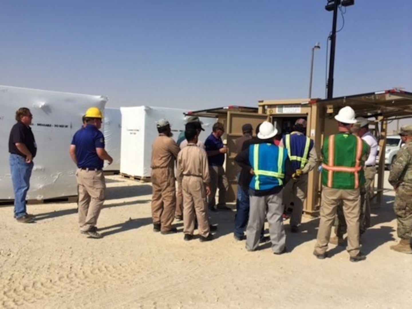 Representatives from the Camp Arifjan, Kuwait, Director of Public Works, Idaho National Labs and their expeditionary resource efficiency managers participate in a demonstration of the solar light cart with hydration unit option at Camp Arifjan, Kuwait, Oct. 3, 2018. The demonstration allowed for the DPW and their operations and maintenance personnel to be aware of how to properly set up the units and how to operate and maintain the units to ensure maximum efficiencies.