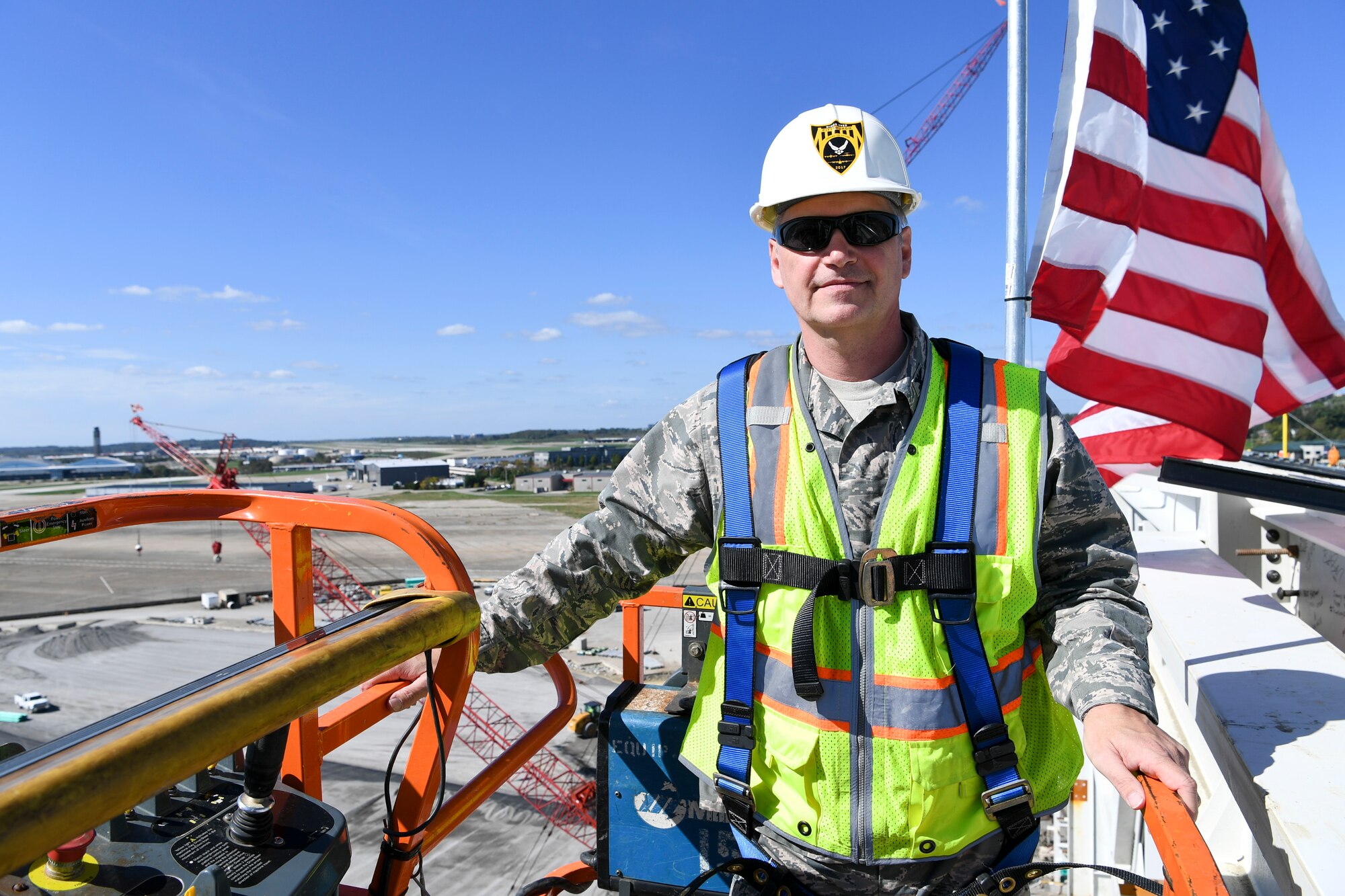 Col. Douglas Strawbridge, commander of the 911th Aiflift Wing, is lifted up to the top of the 911th Airlift Wing's new C-17 hangar at the Pittsburgh International Airport Air Reserve Station, Pennsylvania, Oct. 10, 2017. Strawbridge was signing the final roof beam used for the project, a hangar which will house two C-17 aircraft. (U.S. Air Force photo by Senior Airman Beth Kobily)