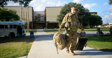 Deployers from Headquarters Company, 89th Military Police Brigade, unload their equipment into their temporary lodging quarters at Joint Base San Antonio-Lackland in support of Operation Faithful Patriot Oct. 29. The Headquarters Company, 89th Military Police Brigade, who are deploying Soldiers, will provide a range of support including planning assistance, engineering support, equipment and resources to assist the Department of Homeland Security along the southwest border.