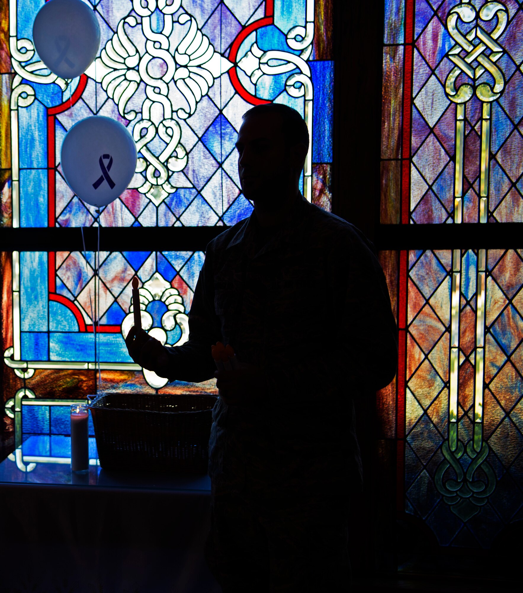 U.S. Air Force Senior Airman Daniel Caraglio, 20th Medical Operations Squadron mental health technician, passes out candles to Team Shaw members attending a candlelight vigil at Shaw Air Force Base, S.C., Oct. 30, 2018.