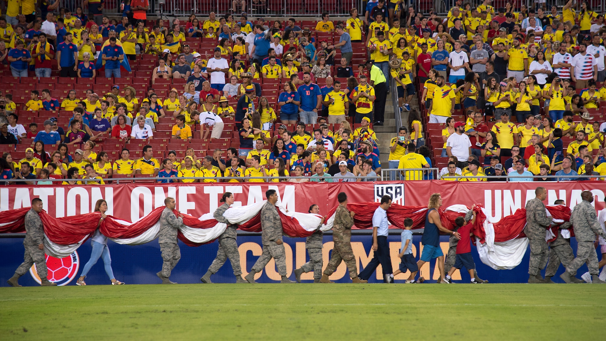 Around 100 military members and their families participate in a flag presentation ceremony before an exhibition match between the U.S. Soccer Men’s National Team and the Colombian National Team at Raymond James Stadium, Tampa, Fla., Oct. 11, 2018.  The USMNT provides military members the opportunity to present the American flag before every game.