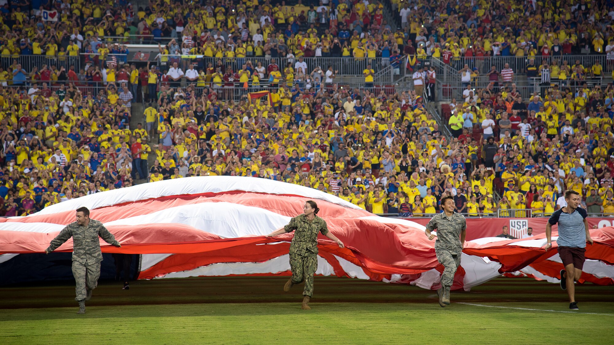 Around 100 military members and their families participate in a flag presentation ceremony before an exhibition match between the U.S. Soccer Men’s National Team and the Colombian National Team at Raymond James Stadium, Tampa, Fla., Oct. 11, 2018.  The USMNT provides military members the opportunity to present the American flag before every game.
