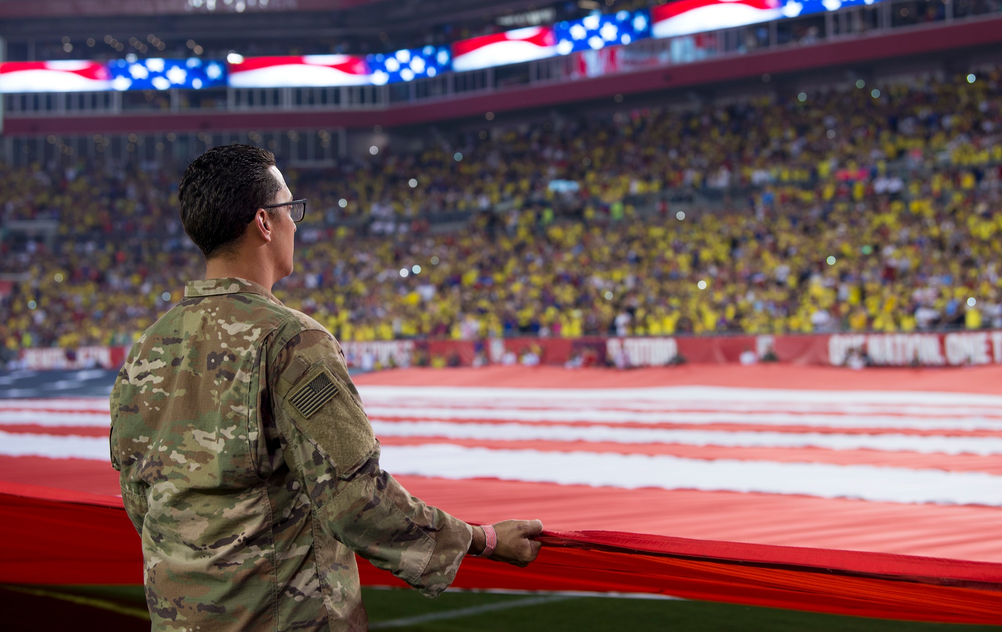 Around 100 military members and their families participate in a flag presentation ceremony before an exhibition match between the U.S. Soccer Men’s National Team and the Colombian National Team at Raymond James Stadium, Tampa, Fla., Oct. 11, 2018.  The USMNT provides military members the opportunity to present the American flag before every game.