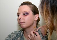 Master Sgt. Navon Martin, Mental Health Clinic flight chief receives a faux black eye and neck trauma Oct. 26 during the Black Eye Campaign at Wilford Hall Ambulatory Surgical Center on Joint Base San Antonio-Lackland. During the campaign, volunteers simulated a black eye or other sign of trauma to see who would ask them about their “injury” in an effort to raise awareness of domestic violence.