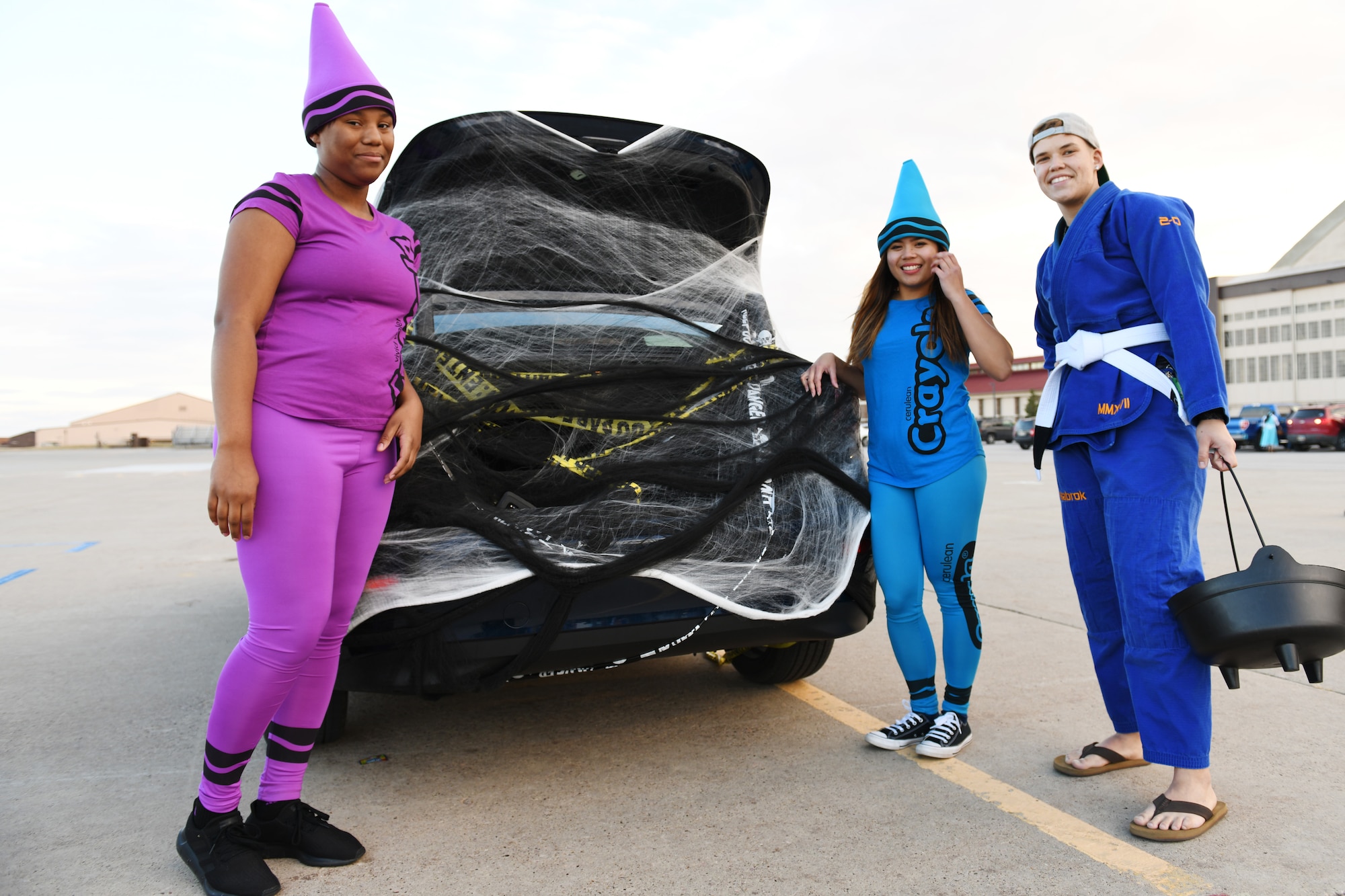 Airman 1st Class Phyre Spann, Airman 1st Class Glyssa Quemado and Airman 1st Class Keren York, all 28th Maintenance Squadron avionics technicians, volunteer at the Trunk or Treat event at Ellsworth Air Force Base, S.D., Oct. 26, 2018. Volunteers from the 28th Bomb Wing decorated their personal and work vehicles with Halloween themes and put them on display. (U.S. Air Force photo by Airman 1st Class Christina Bennett)