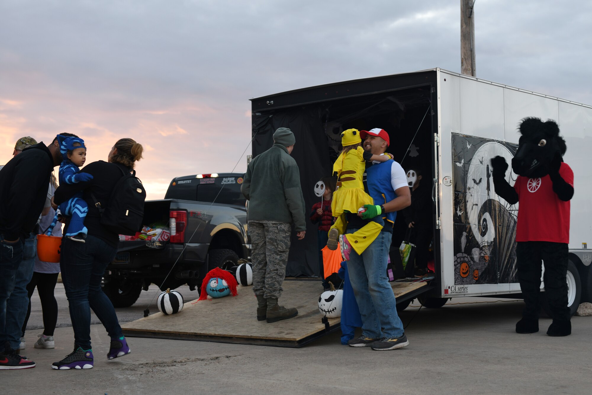 Children and their families wait in line before entering a “Nightmare Before Christmas” themed trailer provided by the 28th Logistics Readiness Squadron at Ellsworth Air Force Base, S.D., Oct. 26, 2018. Volunteers from the 28th Bomb Wing decorated their personal and work vehicles with Halloween themes and put them on display. (U.S. Air Force photo by Airman 1st Class Christina Bennett)