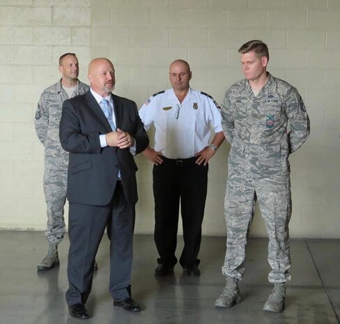 Air Force Fire Chief Jeff Wagner (left) presents Master Sgt. Andrew Kehl, 99th Civil Engineer Squadron deputy fire chief, with a coin at Nellis Air Force Base, Nev. Kehl was named the Department of Defense Senior Fire Officer of the year for 2017. (Courtesy photo)