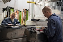 Senior Airman Kory Krause, 673d Logistics Readiness Squadron mission generation vehicle and vehicular equipment maintenance journeyman, and Airman 1st Class Shane Ousdahl, 673d Logistics Readiness Squadron fire truck and refueling mechanic, perform maintenance on a fire truck at Fire Station 1 on Joint Base Elmendorf-Richardson, Alaska, Sep. 17, 2018. Fire truck and refueling mechanics perform daily care on fire trucks while also following monthly and yearly maintenance checklists.