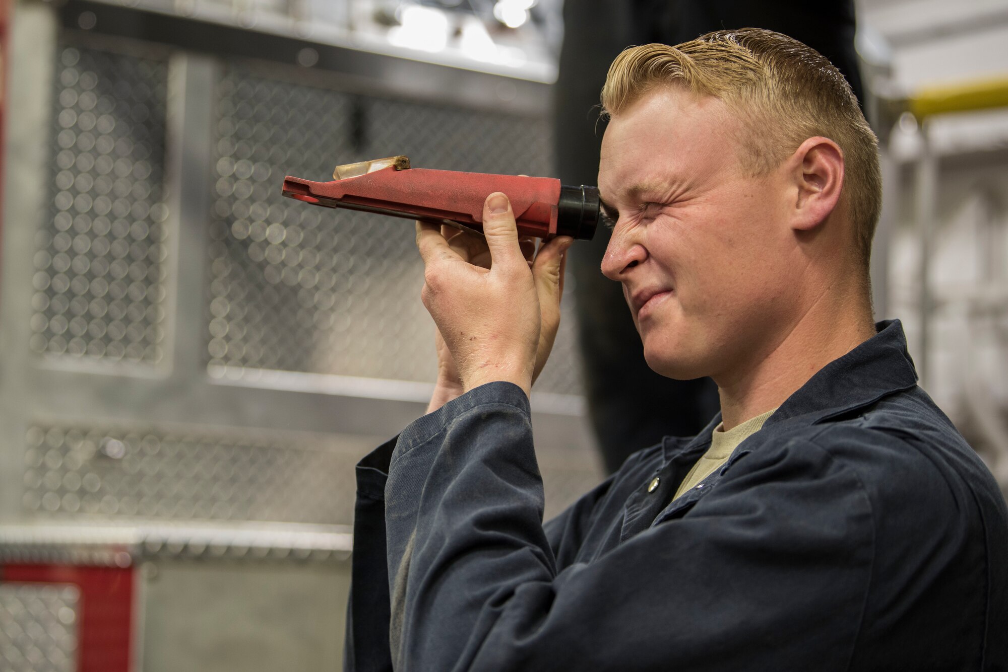 Airman 1st Class Shane Ousdahl, 673d Logistics Readiness Squadron fire truck and refueling mechanic, looks through a refractometer at Fire Station 1 on Joint Base Elmendorf-Richardson, Alaska, Sep. 17, 2018. Fire truck and refueling mechanics perform daily care on fire trucks while also following monthly and yearly maintenance checklists.