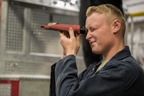 Airman 1st Class Shane Ousdahl, 673d Logistics Readiness Squadron fire truck and refueling mechanic, looks through a refractometer at Fire Station 1 on Joint Base Elmendorf-Richardson, Alaska, Sep. 17, 2018. Fire truck and refueling mechanics perform daily care on fire trucks while also following monthly and yearly maintenance checklists.