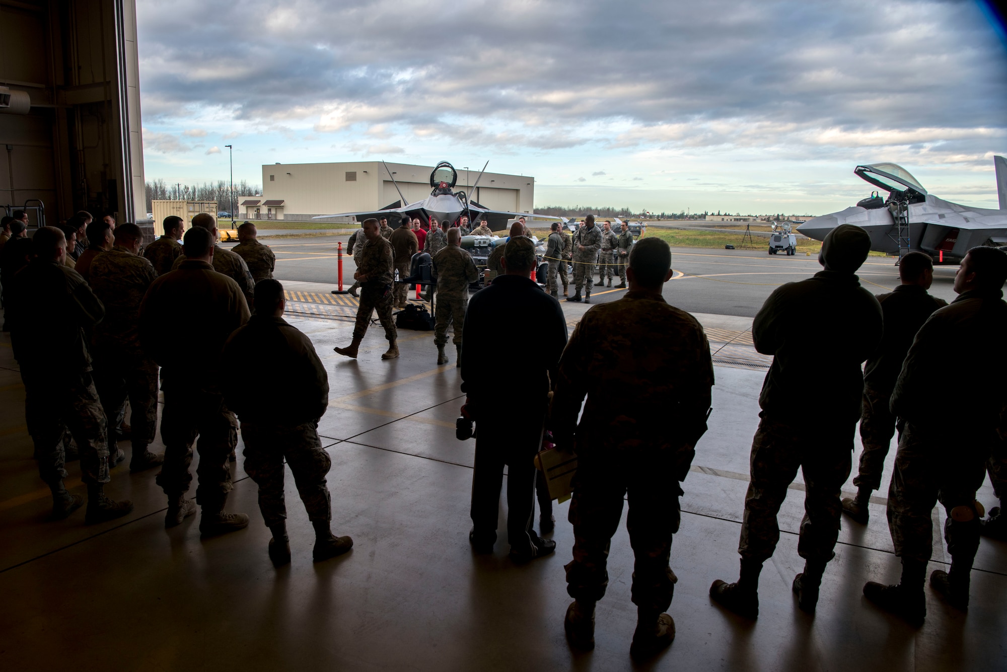 Attendees gathered to watch service members from the 525th and 90th aircraft maintenance units compete during the quarterly load competition at Joint Base Elmendorf-Richardson, Alaska, Oct. 26, 2018. During the competition two teams tested their skills as load crew members for the F-22 Raptor aircraft. The event demonstrates the skill level and knowledge of all JBER aircraft maintainers.