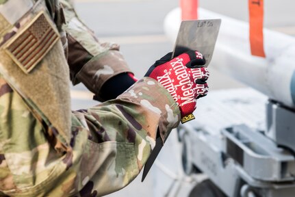 U.S. Air Force Airman 1st Class Anthony Lewis, a 90th Aircraft Maintenance Unit weapons load crew member, prepares to attach a stabilization fin to an AIM-120 Advanced Medium Range Air-to-Air Missile during the quarterly load competition at Joint Base Elmendorf-Richardson, Alaska, Oct. 26, 2018. The AIM-120 is a medium range missile for air intercept and has an approximate weight of 358 lbs.