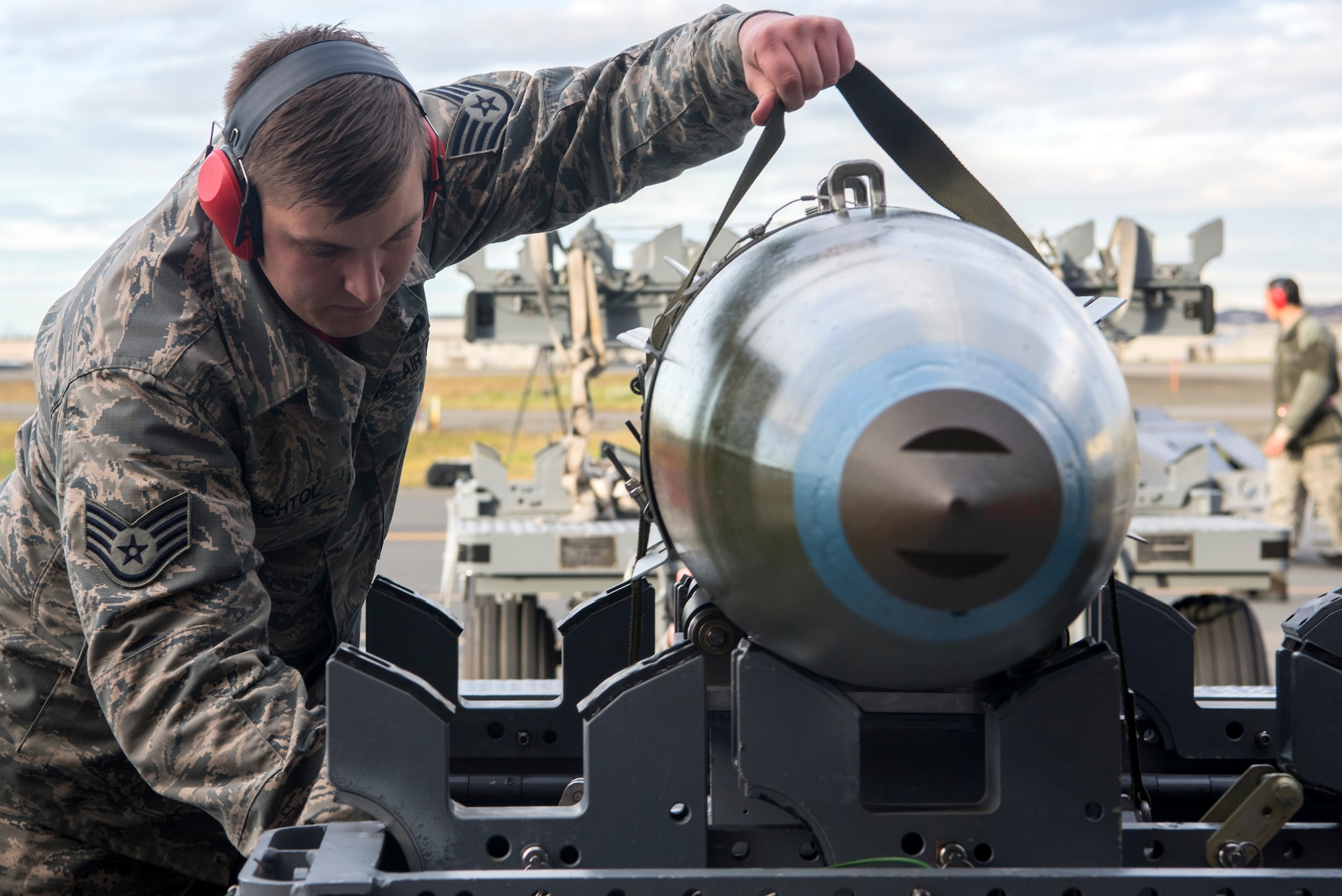 U.S. Air Force Staff Sgt. Taylor Bechtol, a 90th Aircraft Maintenance Unit weapons load crew chief, loosens the straps on a GBU-32 Joint Direct Attack Munition (JDAM) during the quarterly load competition at Joint Base Elmendorf-Richardson, Alaska, Oct. 26, 2018. The JDAM is used for accurate, adverse weather conventional strikes and weighs approximately 1,000 lbs.