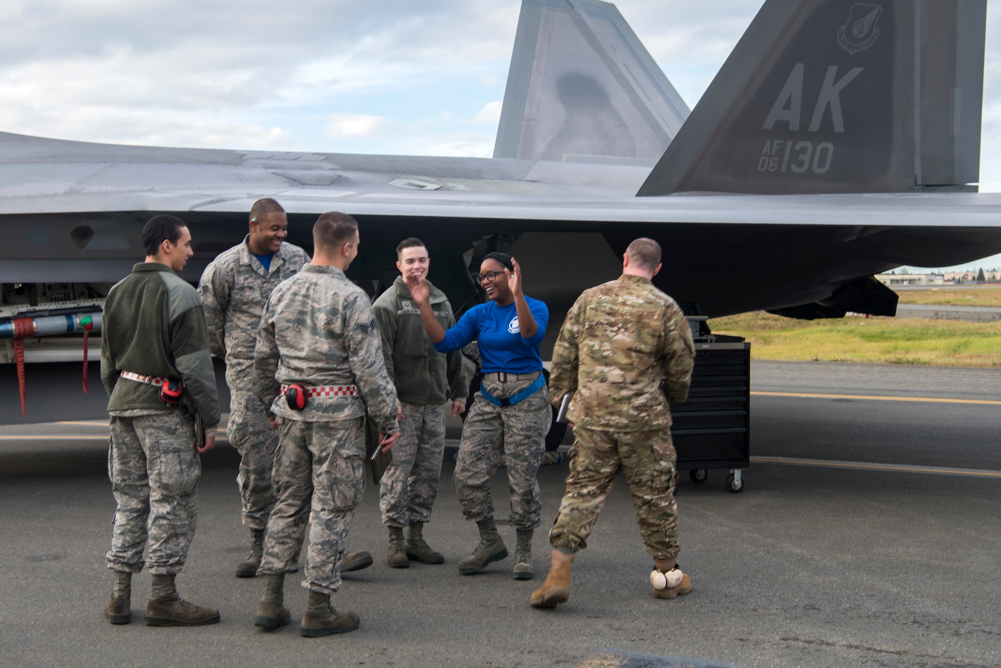 Service members from the 525th Aircraft Maintenance Unit crew celebrate after completing the quarterly load competition at Joint Base Elmendorf-Richardson, Alaska, Oct. 26, 2018. During the competition, two teams tested their skills as load crew members for the F-22 Raptor. The event demonstrates the skill level and knowledge of all JBER aircraft maintainers.