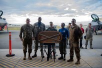 U.S. Air Force Lt. Col. Joshua Pope, 3rd Maintenance Group deputy commander, 525th Aircraft Maintenance Unit winning crew, and U.S. Air Force Chief Master Sgt. Paul Nightingale, 3rd Maintenance Group wing weapons manager, pose for a photo following the quarterly load competition at Joint Base Elmendorf-Richardson, Alaska, Oct. 26, 2018. The competition consisted of two teams testing their skills as load crew members for the F-22 Raptor aircraft. The event is held to demonstrate the skill level and knowledge of all JBER aircraft maintainers.