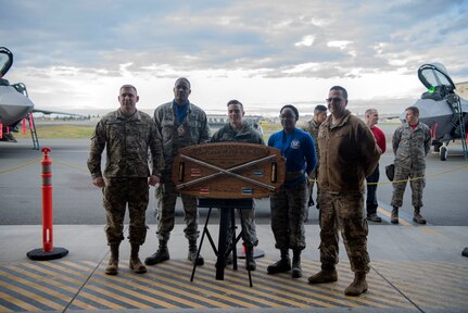 U.S. Air Force Lt. Col. Joshua Pope, 3rd Maintenance Group deputy commander, 525th Aircraft Maintenance Unit winning crew, and U.S. Air Force Chief Master Sgt. Paul Nightingale, 3rd Maintenance Group wing weapons manager, pose for a photo following the quarterly load competition at Joint Base Elmendorf-Richardson, Alaska, Oct. 26, 2018. The competition consisted of two teams testing their skills as load crew members for the F-22 Raptor aircraft. The event is held to demonstrate the skill level and knowledge of all JBER aircraft maintainers.