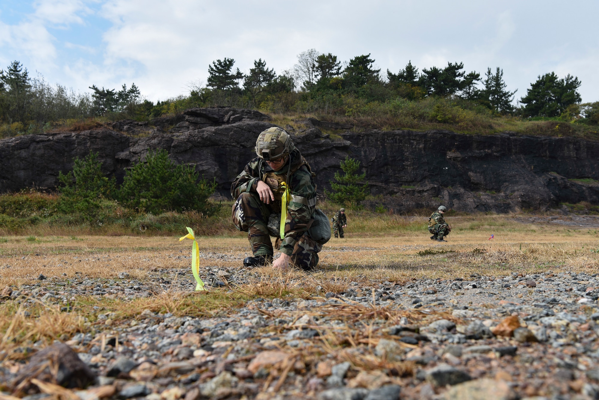 Explosive Ordnance Disposal Airmen from the 8th Civil Engineer Squadron place and activate training charges at Kunsan Air Base, Republic of Korea, Oct. 29, 2018. Routine practice scenarios such as this help the team improve safety, speed, and efficiency while also reinforcing readiness. (U.S. Air Force photo by Senior Airman Savannah Waters)