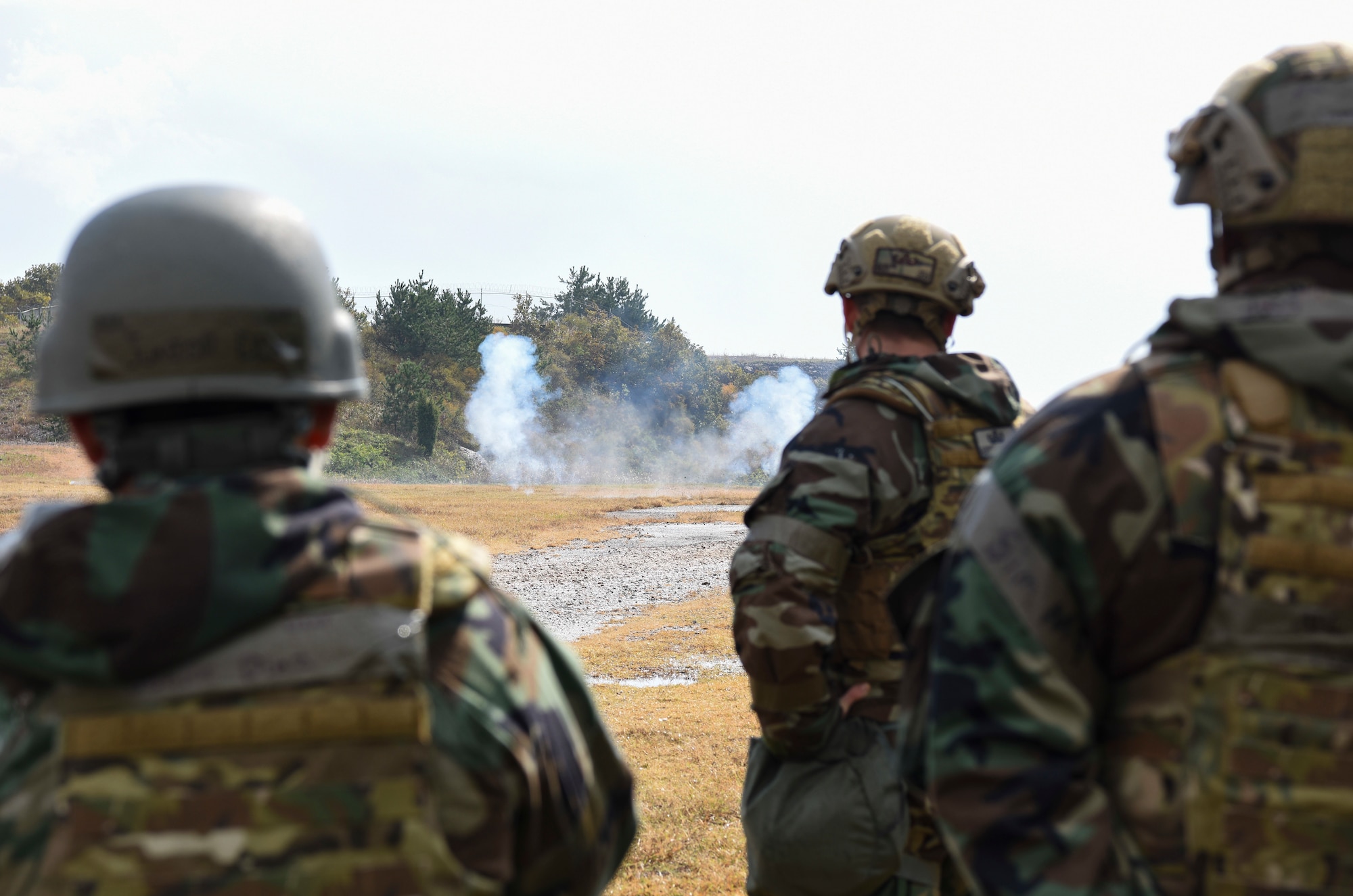 Explosive Ordnance Disposal Airmen from the 8th Civil Engineer Squadron observe training charges detonating at Kunsan Air Base, Republic of Korea, Oct. 29, 2018. EOD members are trained to detect, disarm, detonate and dispose of explosives, routine practice scenarios such as this, help the team improve safety, speed, and efficiency while also reinforcing readiness. (U.S. Air Force photo by Senior Airman Savannah Waters)