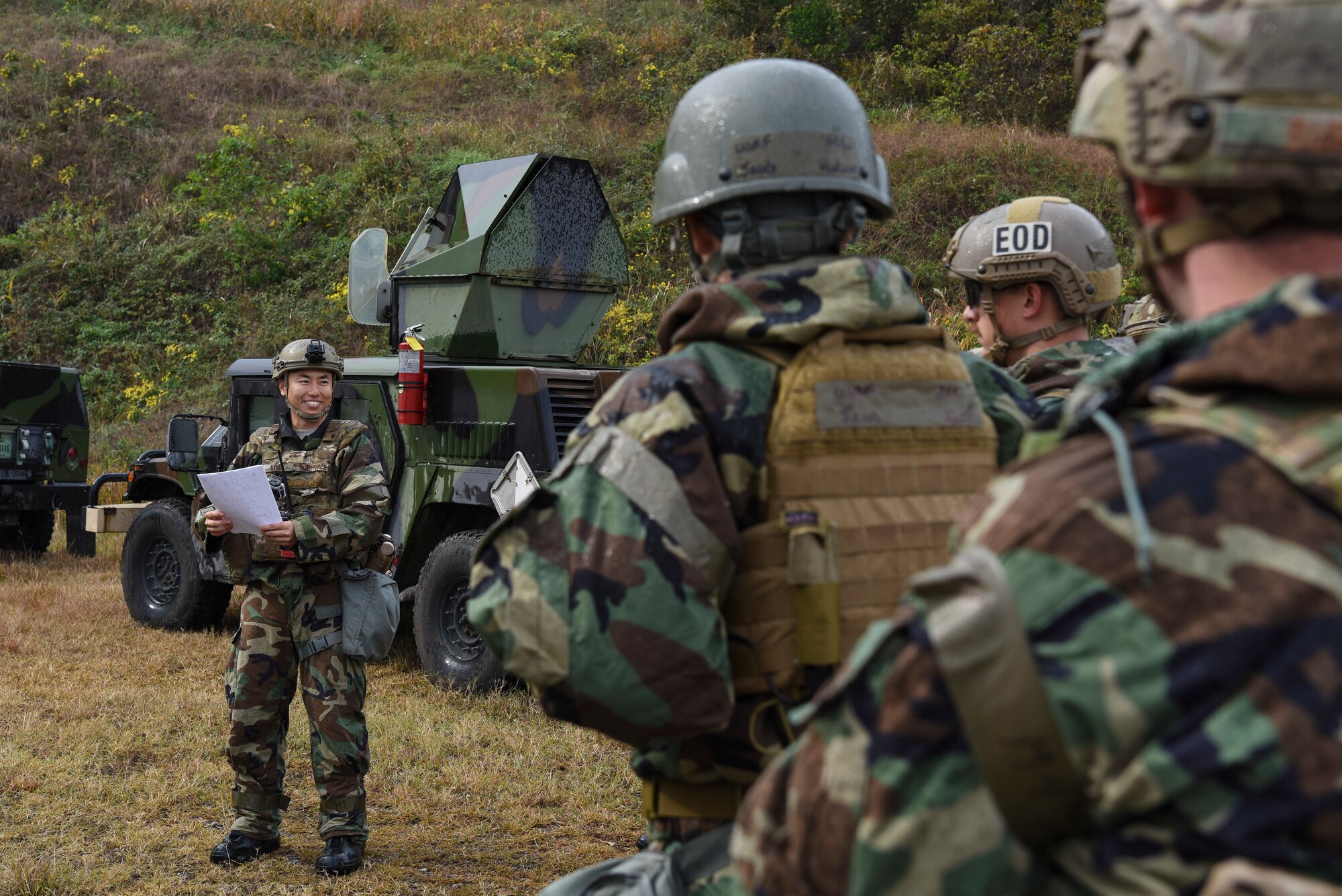 Explosive Ordnance Disposal Airmen from the 8th Civil Engineer Squadron hold a safety briefing before prepping training demolition charges at Kunsan Air Base, Republic of Korea, Oct. 29, 2018. EOD technicians conduct training to learn the proper tactics, techniques and procedures to safely detonate explosives on a routine basis to improve their expertise and ability to act quickly in any scenario. (U.S. Air Force photo by Senior Airman Savannah Waters)