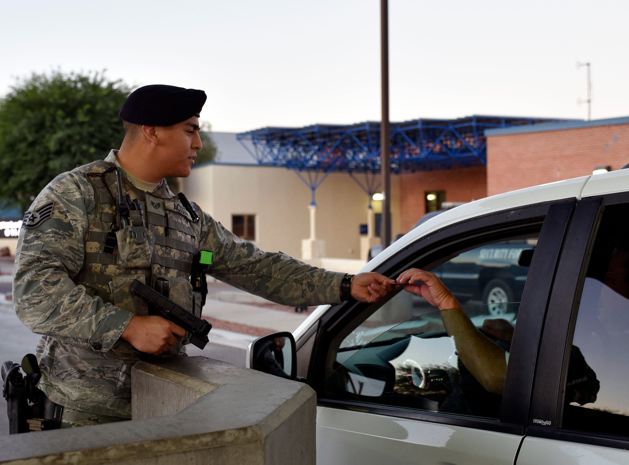 Air Force Staff Sgt. Rodrigo Acosta, a security forces specialist with the Arizona Air National Guard's 162nd Wing, conducts an identification check at Tucson Air National Guard Base in Tucson, Arizona, Sept. 8, 2018. When not wearing an Air Force uniform as a security forces specialist, Acosta serves as a police officer for the Tucson Police Department. "Both jobs have the same mindset when it comes to teamwork and building trust among your comrades," he said.