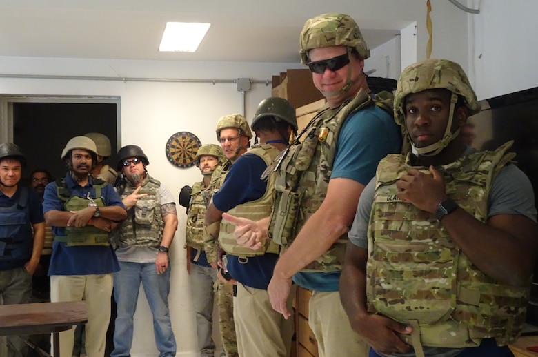 Waiting in the bunker room at Camp Black are from left; Versar contractors, Nathan Alford, Operations and Maintenance (O&M) COR); Tyler Crumbley, Quality Assurance Manager; Brian Pitt, Electrical Engineer; Versar contractor who is camera shy; Brian Cagle, Project Engineer; and Ronald Clark, Logistics Specialist.