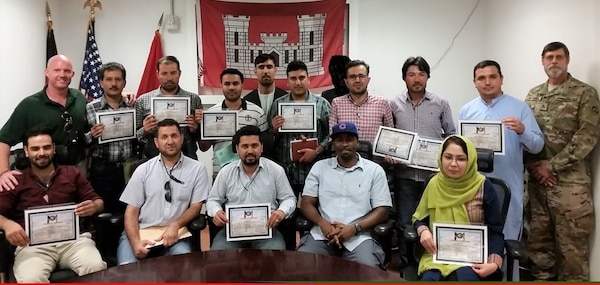 Upon completion of a Three-phased Inspection Training in Kabul, Afghanistan Local National Quality Assurance Engineers receive their Certificates of completion and are joined by members from the New Kabul Compound in acknowledging their accomplishments. (Photo Courtesy of USACE)