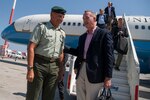 A Greek soldier welcomes Marine Corps Gen. Joe Dunford, chairman of the Joint Chiefs of Staff, to Athens, Greece.