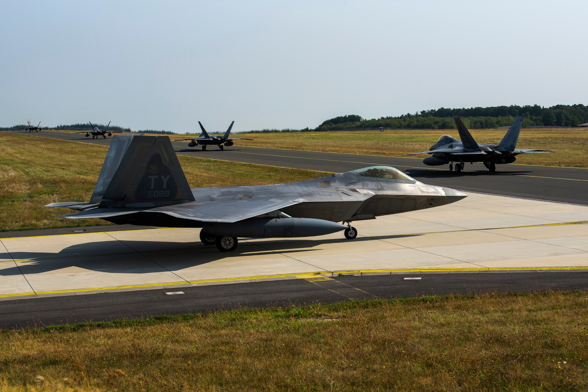 U.S. Air Force F-22 Raptors from the 95th Fighter Squadron, 325th Fighter Wing, Tyndall Air Force Base, Fla., taxi on the flightline at Spangdahlem Air Base, Germany, Aug. 29, 2018. The aircraft prepared to depart after being deployed to Europe for several weeks to train with allied forces. (U.S. Air Force photo by Airman 1st Class Valerie Seelye)